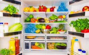 open refrigerator stocked with produce