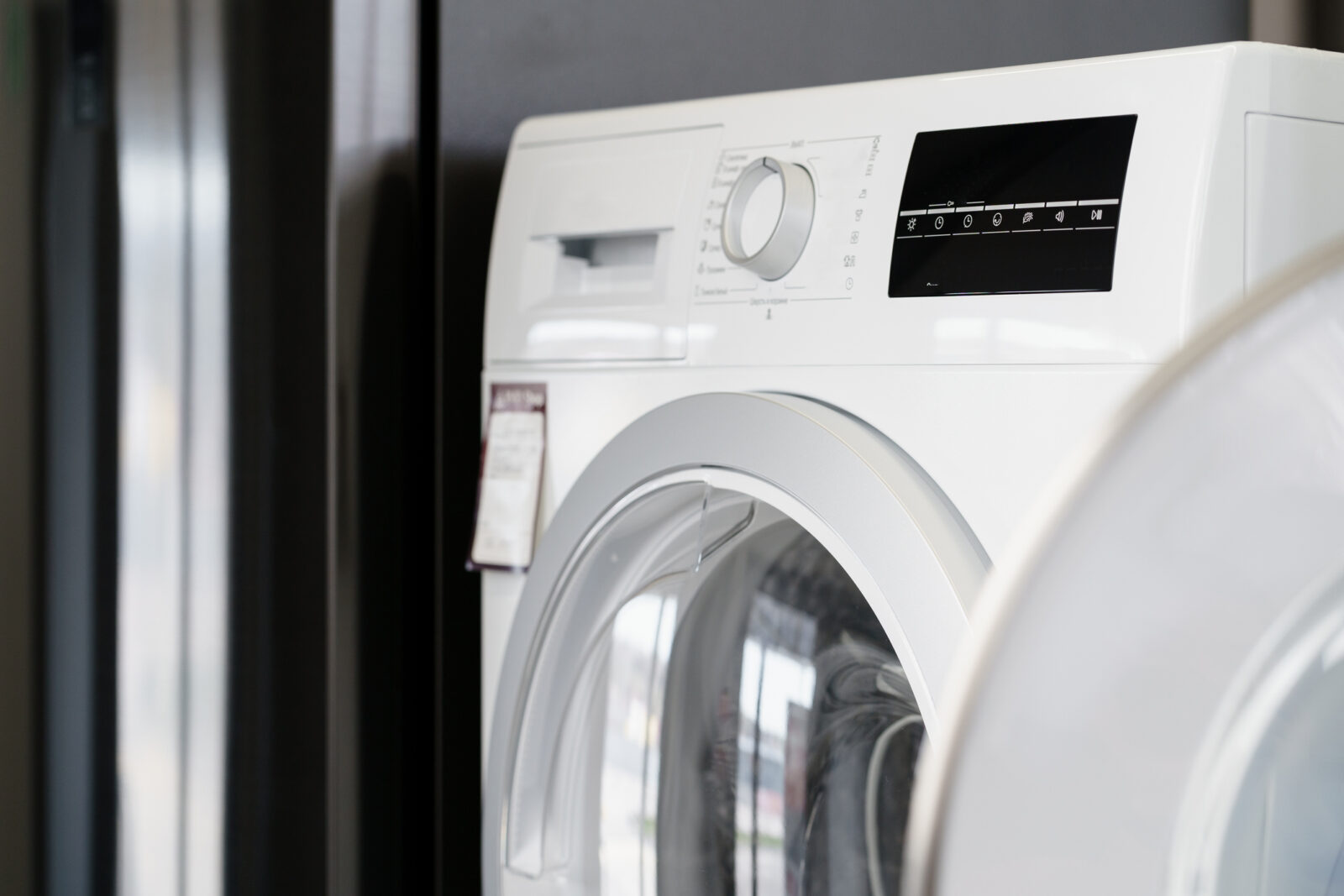 Close up photo of new dryer machine in household appliances store