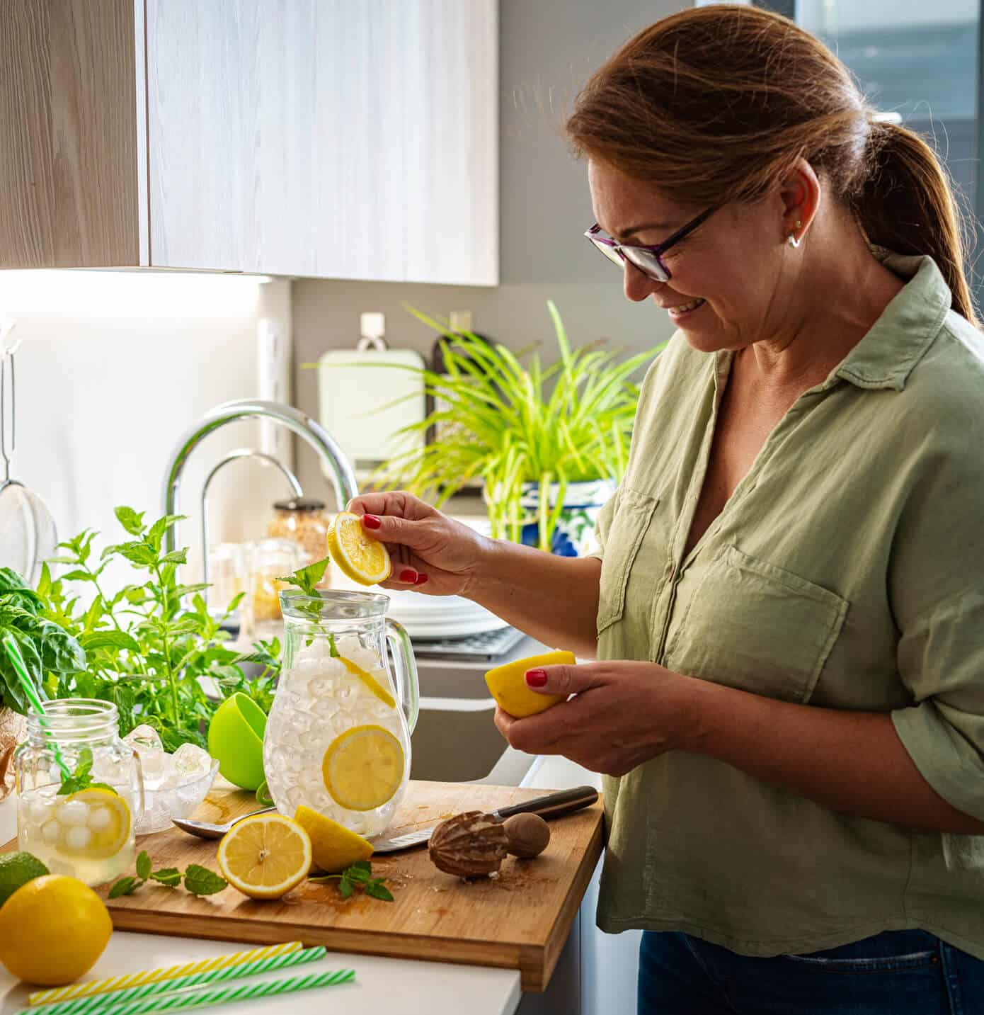 A woman makes refreshing glasses of lemonade after ice maker repair services in Baltimore, MD from Landers Appliance.
