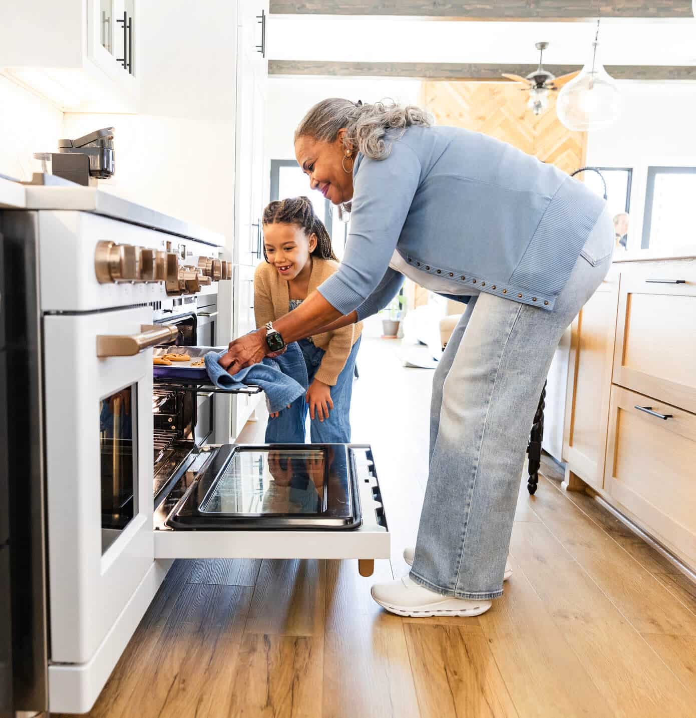 A grandmom and grandaughter in Baltimore, MD are baking cookies after oven and wall oven repair from Landers.
