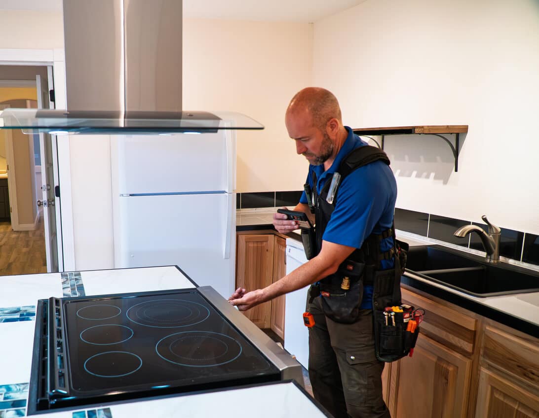 A Landers tech is repairing a cooktop in Baltimore, MD.