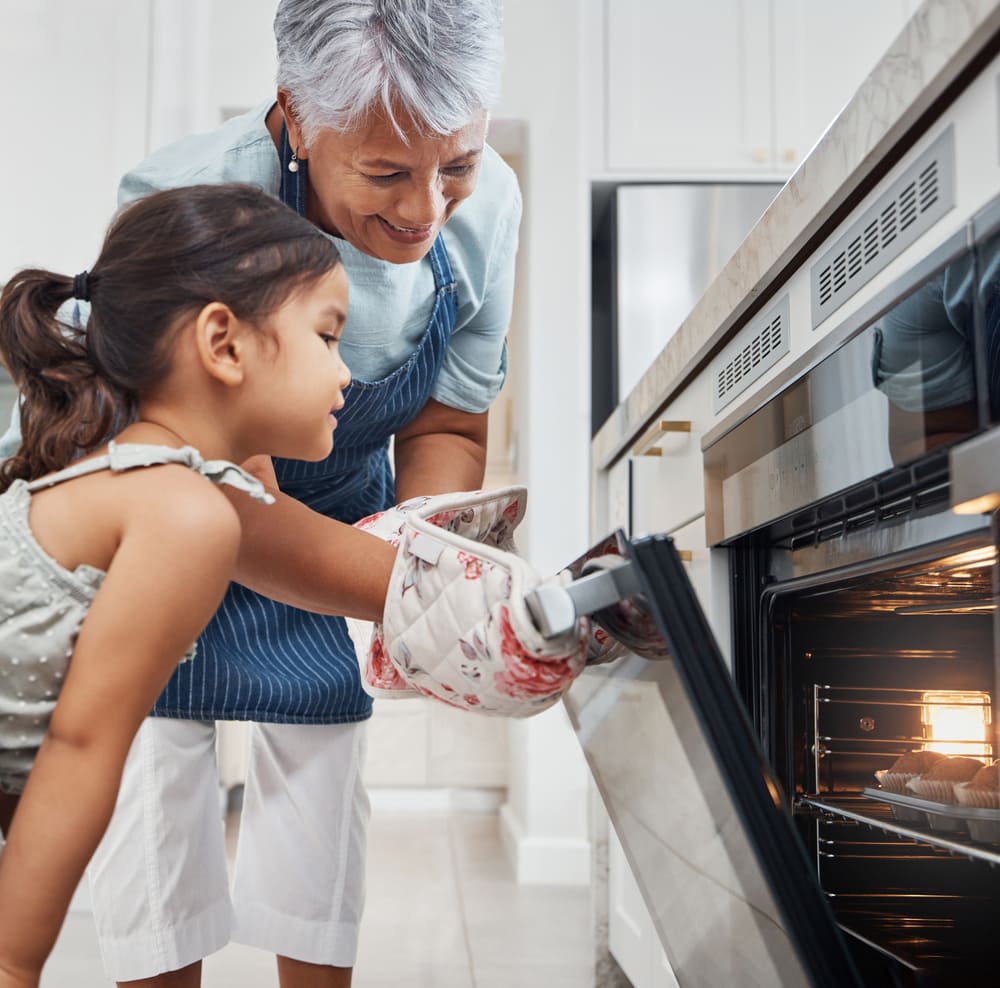 A grandmother and granddaughter can back to baking after Montgomery County oven repair from Landers Appliance.